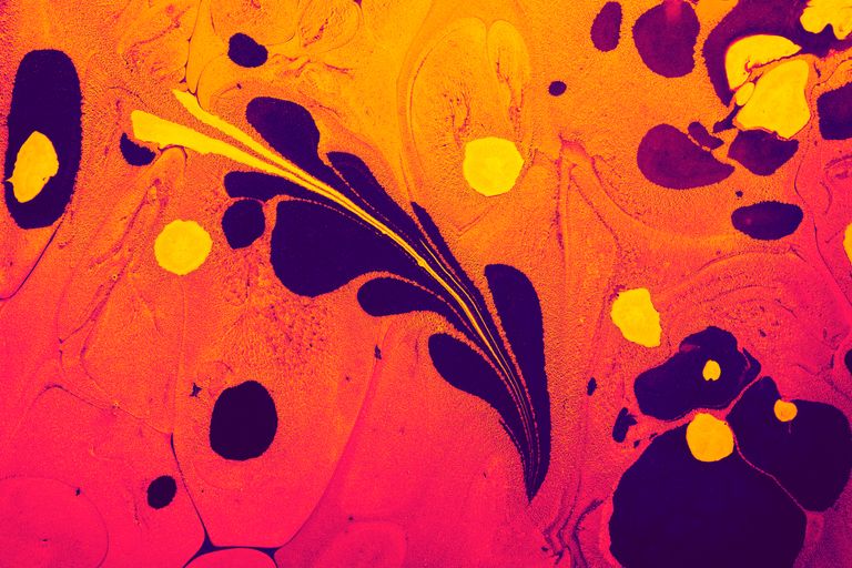 Colorful abstract liquid art with orange, navy, and yellow swirls creating a vibrant texture.