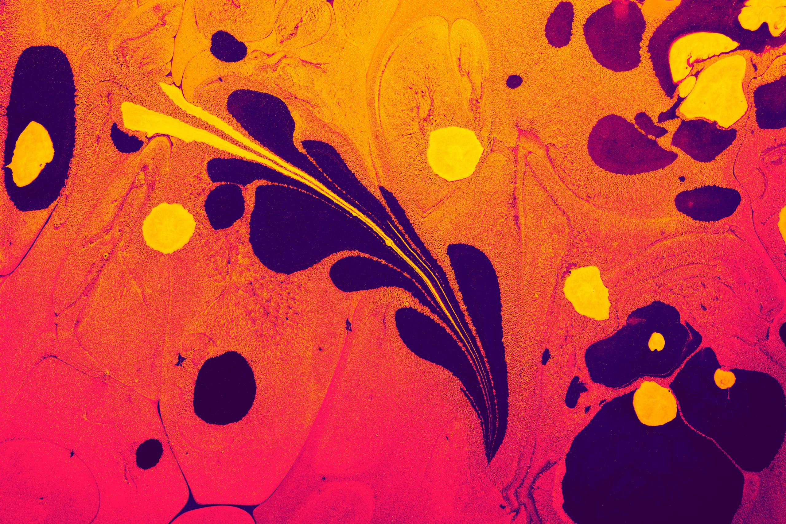 Colorful abstract liquid art with orange, navy, and yellow swirls creating a vibrant texture.