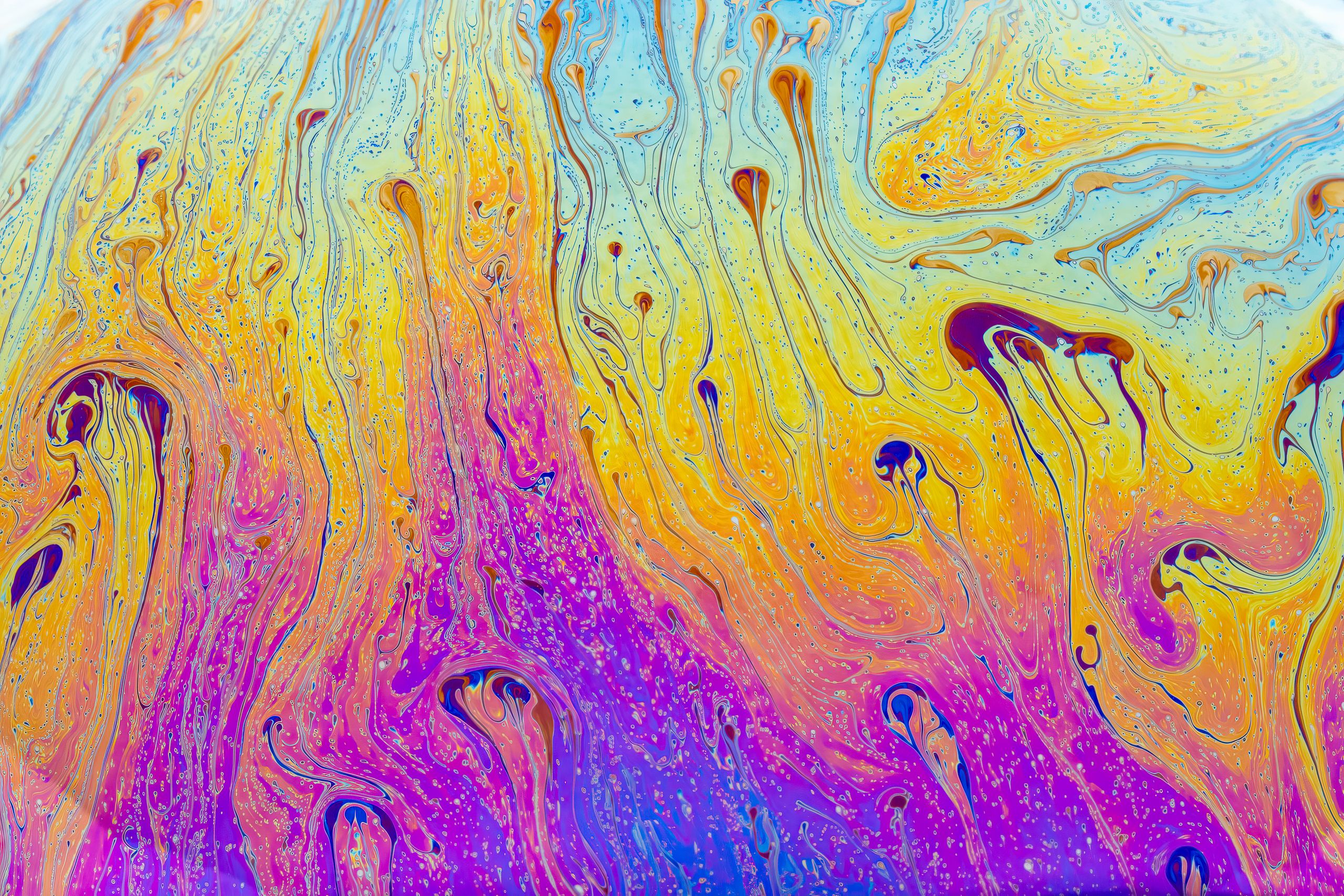 Fluid pattern of swirling vivid colors creating an abstract vibrancy